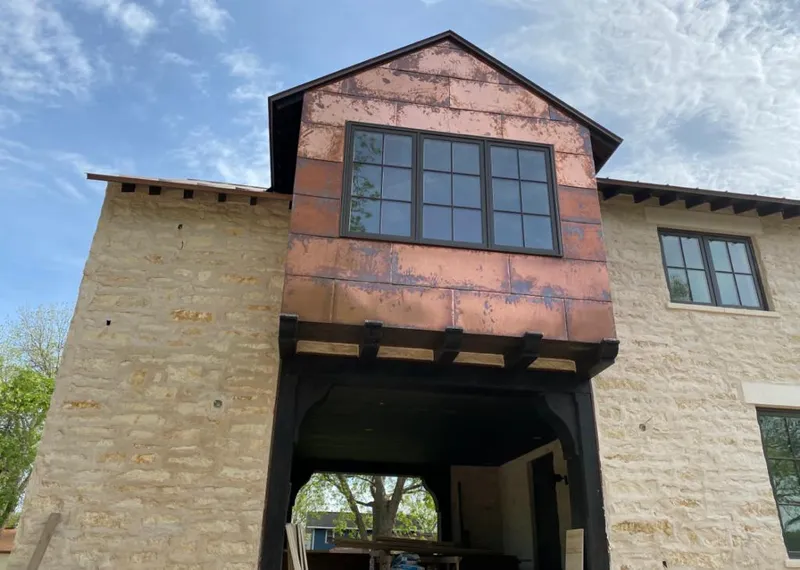Copper metal panel facade on a stone building for Skylight Installation in Jonesboro